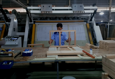 a worker assembling a piece of furniture in vietnam